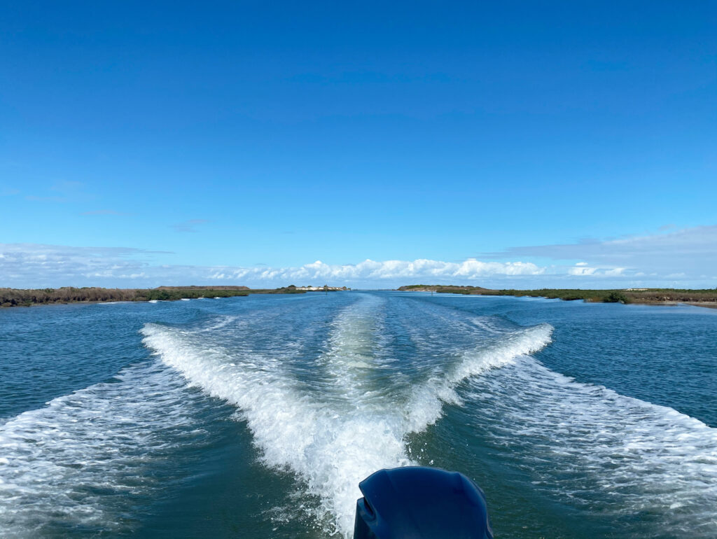 water behind boat blue sky | Port Aransas Explorer