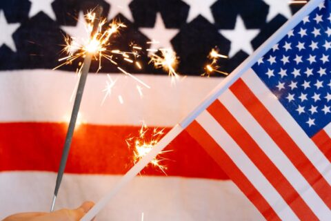sparklers and american flag in hand | Port Aransas Explorer