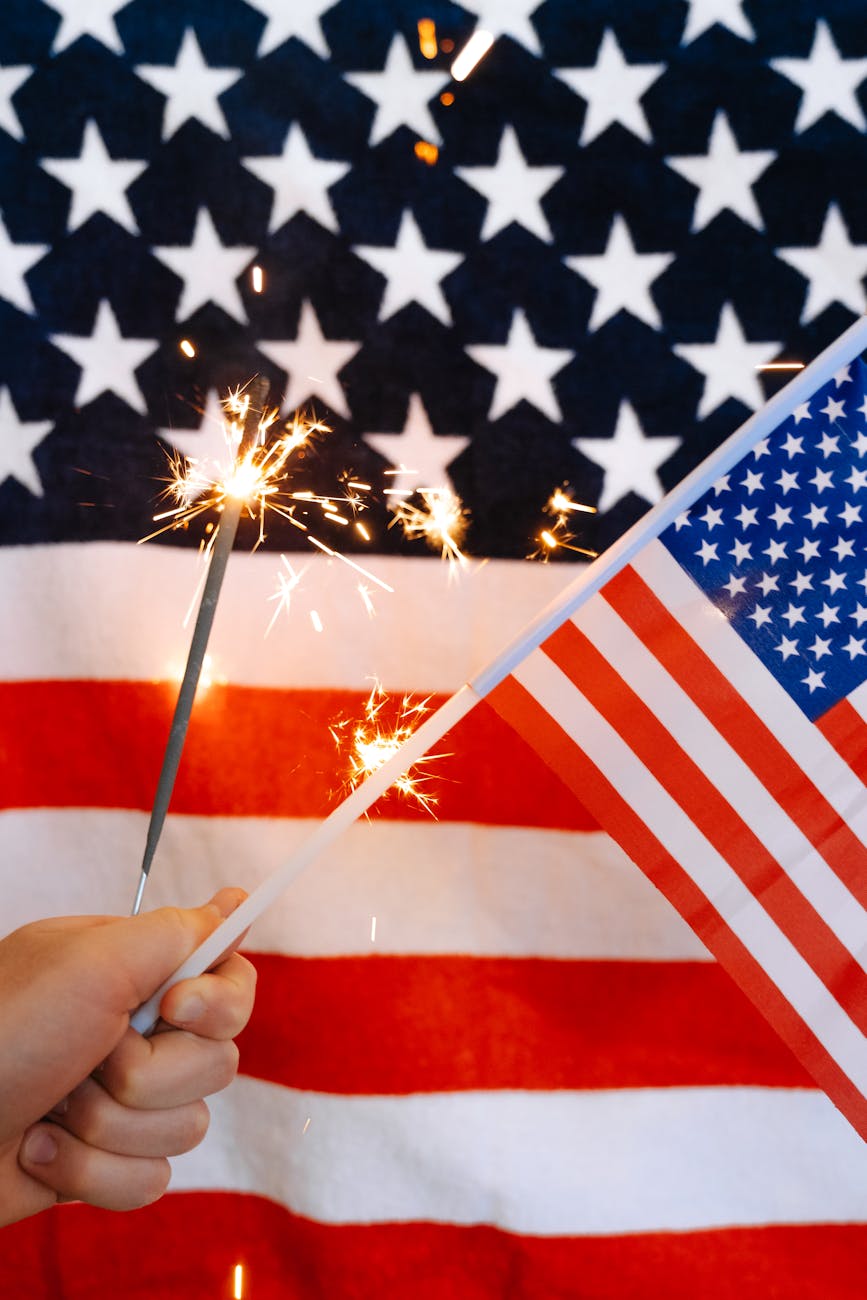 sparklers and american flag in hand | Port Aransas Explorer