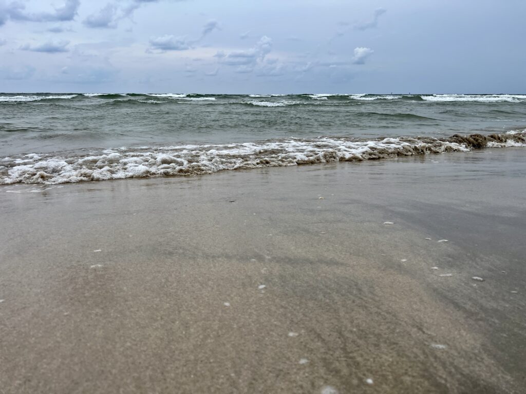rolling waves on beach sand water | Port Aransas Explorer @portaransastex