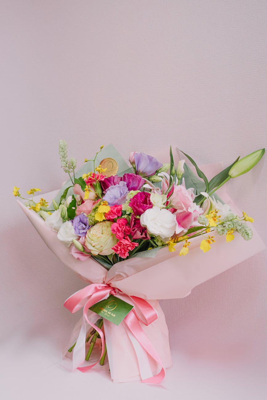 elegant mixed flower bouquet with pink ribbon
