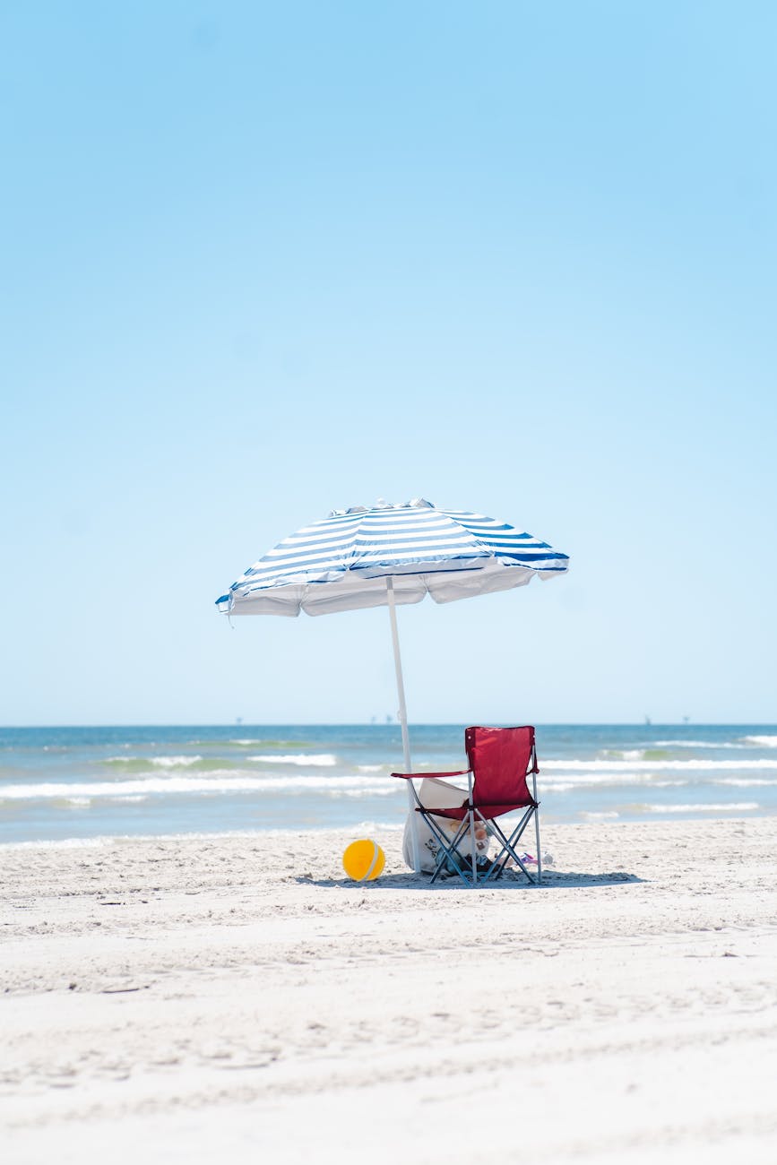 Red chair and umbrella on beach | Port Aransas Explorer